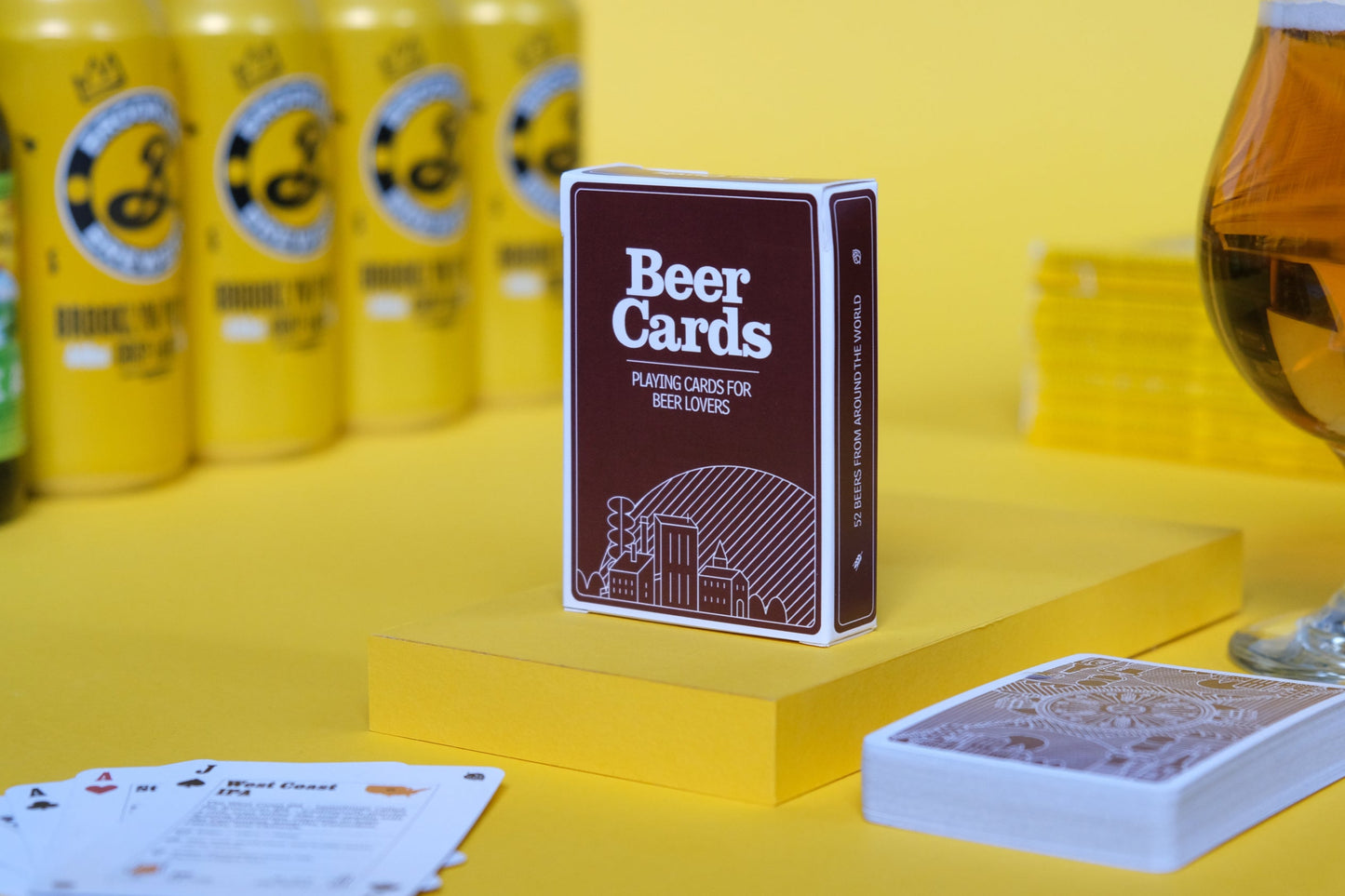 Beer-themed playing cards with a glass of beer and bottles on a yellow background