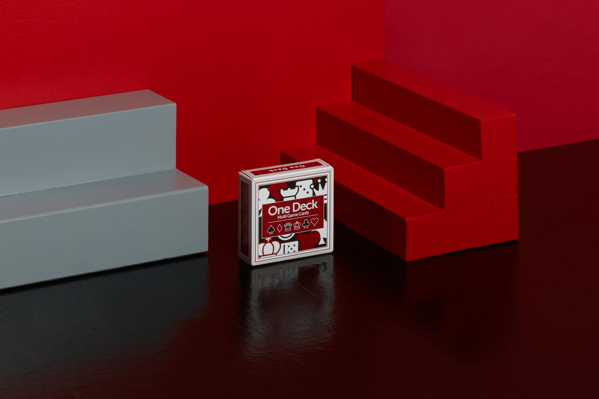 Stylised image of a deck of One Deck Game Cards with red and grey geometric objects