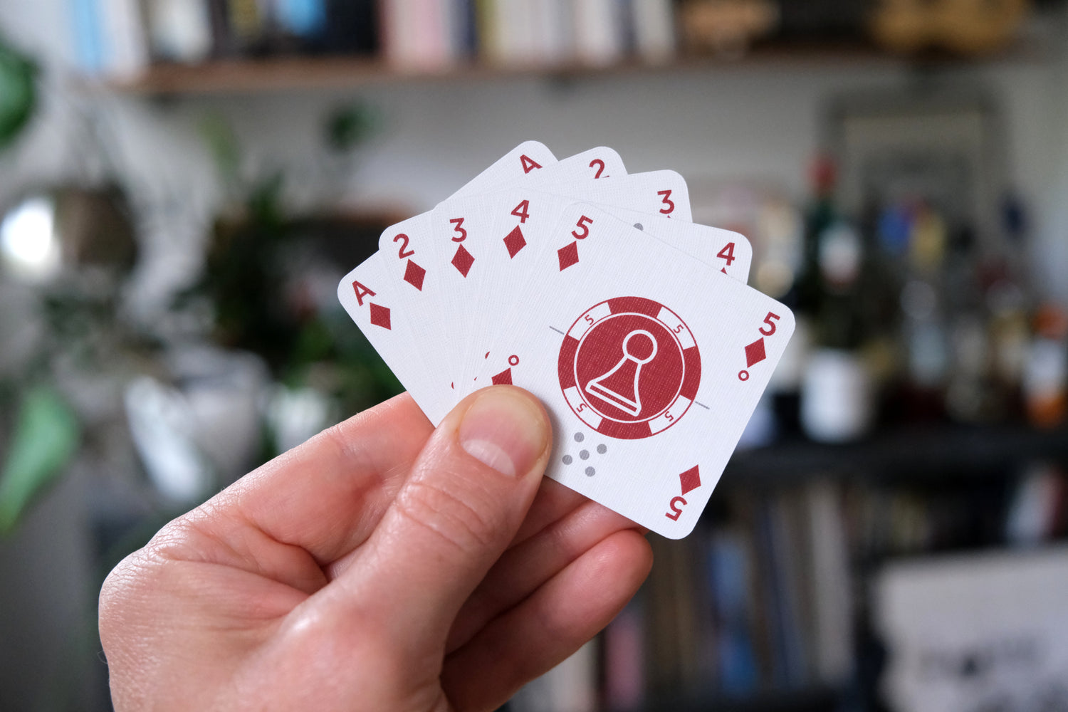 Mini One Deck Game & Score Cards held in a hand