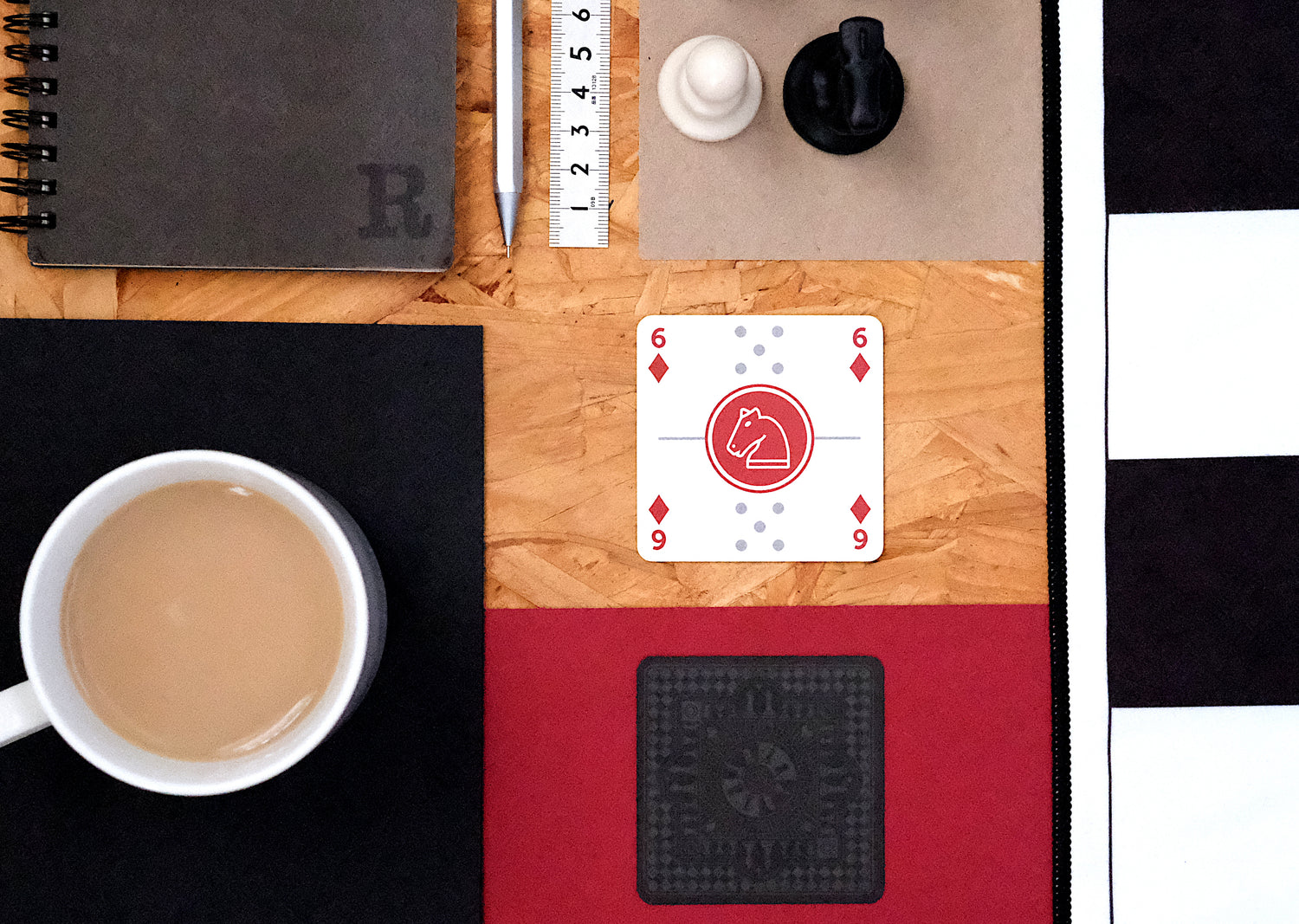 6 hearts, red knight and dominoes card on a table with cup of tea and other objects