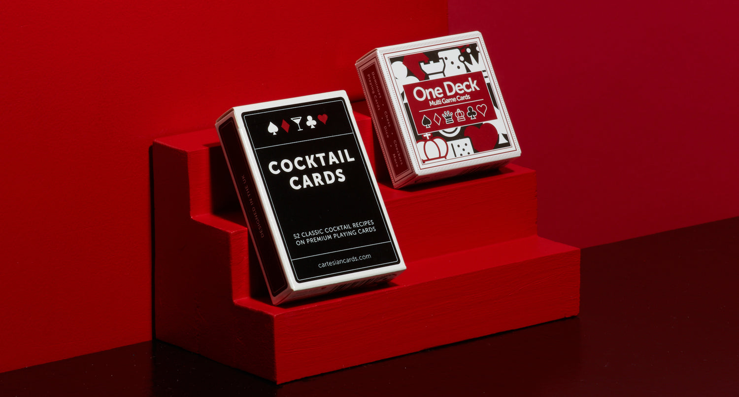 A deck of One Deck Games Cards and a deck Cocktail Cards playing cards by Cartesian Cards