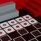 A deck of One Deck Game Cards playing cards laid out to play chess with red and grey geometric objects