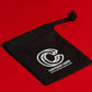 Black playing card travel pouch on a red surface