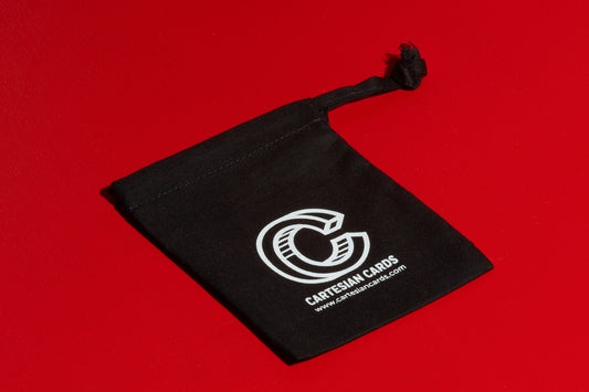 Black playing card travel pouch on a red surface