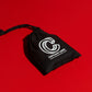 Black playing card travel pouch with deck inside on a red surface